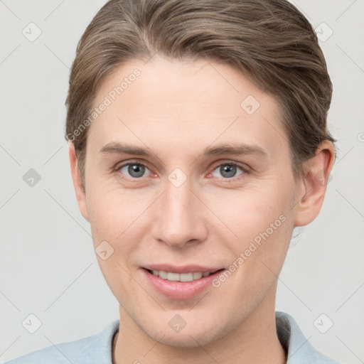 Joyful white young-adult female with short  brown hair and grey eyes