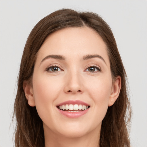 Joyful white young-adult female with long  brown hair and grey eyes