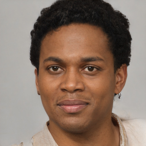 Joyful latino young-adult male with short  brown hair and brown eyes