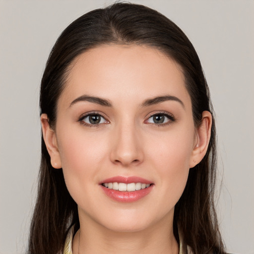 Joyful white young-adult female with long  brown hair and brown eyes