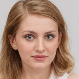 Joyful white young-adult female with long  brown hair and green eyes