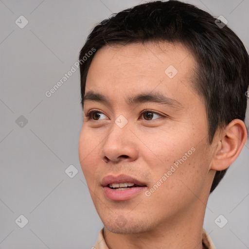 Joyful white young-adult male with short  black hair and brown eyes