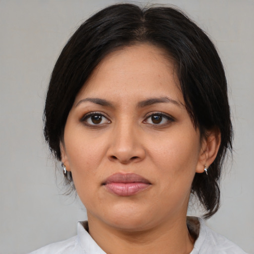 Joyful asian adult female with medium  brown hair and brown eyes