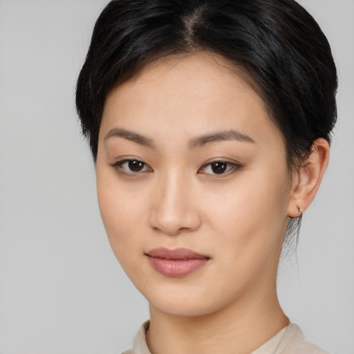Joyful asian young-adult female with short  black hair and brown eyes