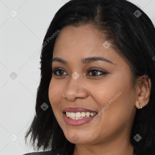 Joyful black young-adult female with long  black hair and brown eyes