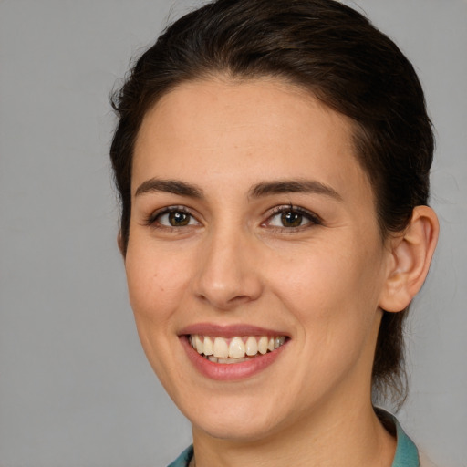 Joyful white young-adult female with medium  brown hair and brown eyes