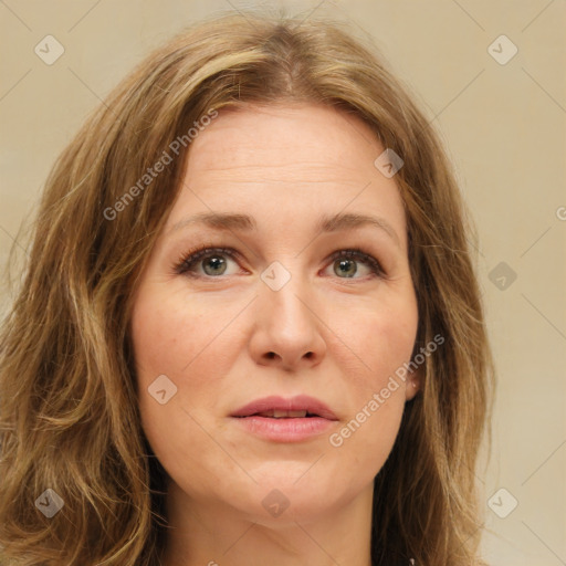 Joyful white adult female with long  brown hair and green eyes