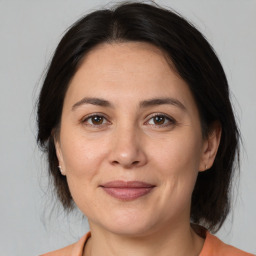 Joyful white adult female with medium  brown hair and brown eyes