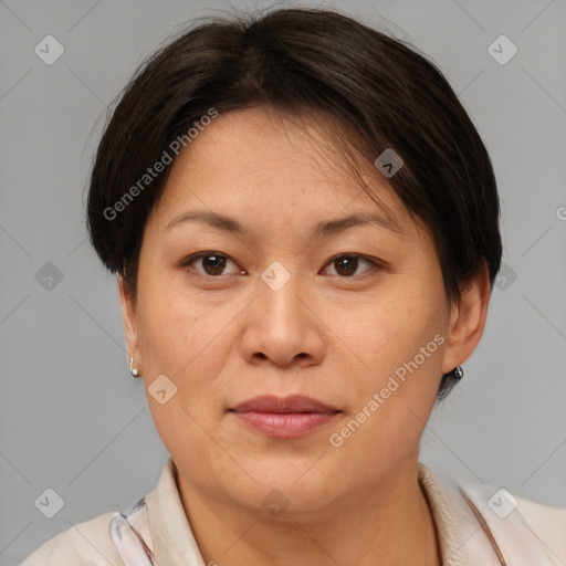 Joyful asian adult female with medium  brown hair and brown eyes