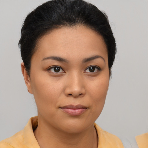 Joyful asian young-adult female with short  brown hair and brown eyes