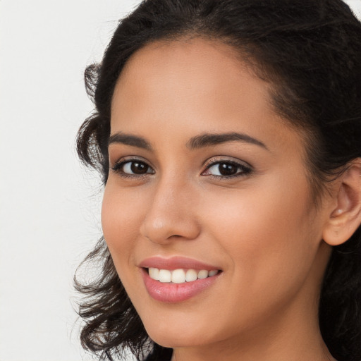 Joyful latino young-adult female with long  brown hair and brown eyes