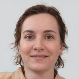 Joyful white young-adult female with medium  brown hair and blue eyes