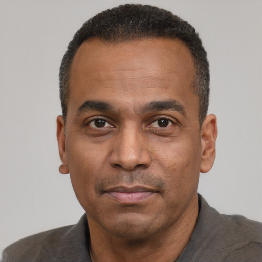 Neutral latino adult male with short  black hair and brown eyes
