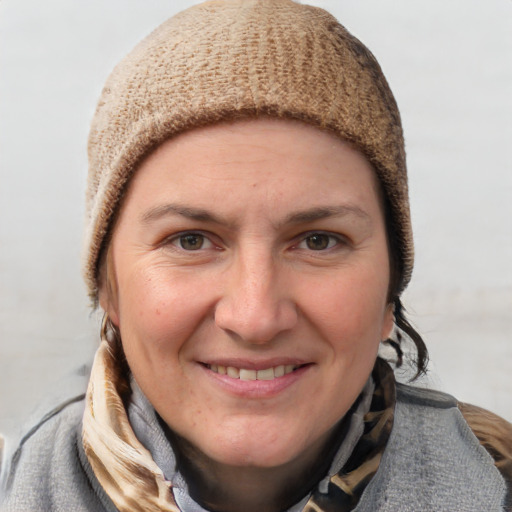 Joyful white young-adult female with short  brown hair and blue eyes