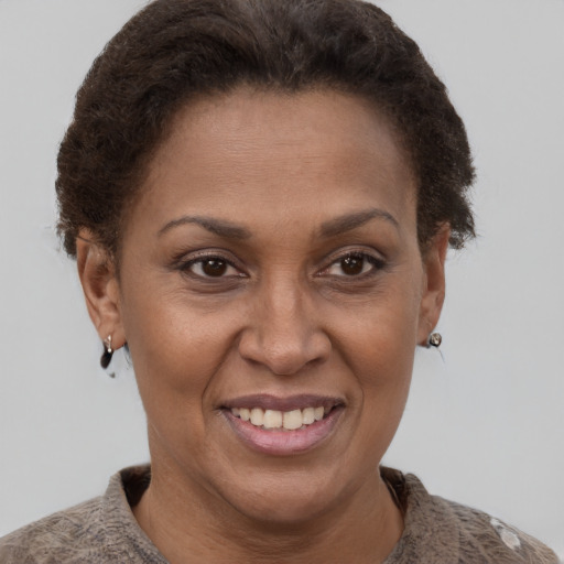 Joyful latino adult female with short  brown hair and brown eyes
