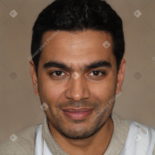 Joyful latino young-adult male with short  black hair and brown eyes