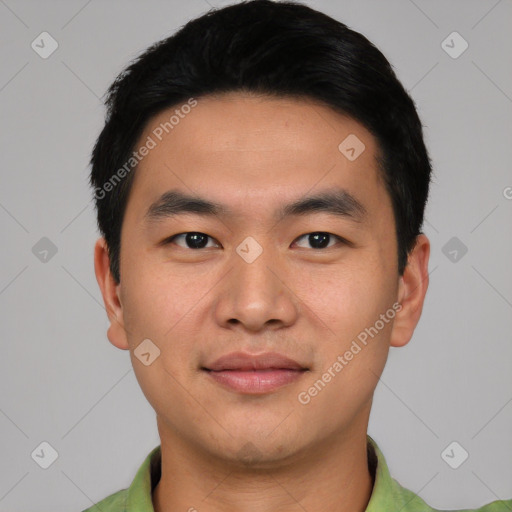 Joyful asian young-adult male with short  black hair and brown eyes