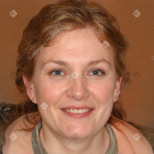 Joyful white adult female with medium  brown hair and blue eyes