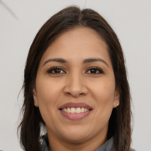 Joyful white young-adult female with long  brown hair and brown eyes