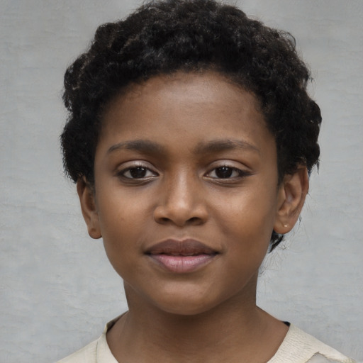 Joyful black child female with short  brown hair and brown eyes