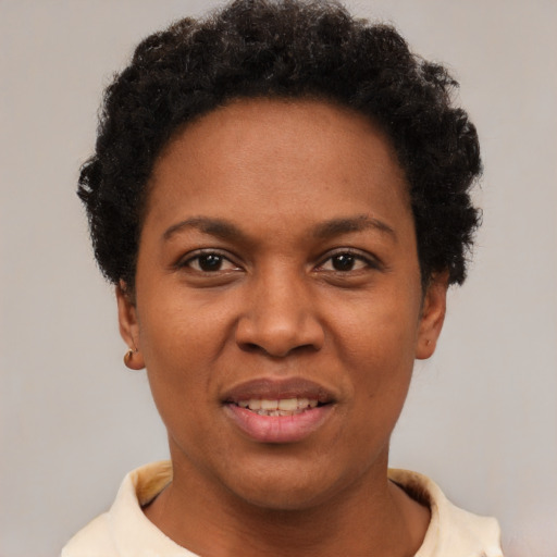 Joyful black adult female with short  brown hair and brown eyes