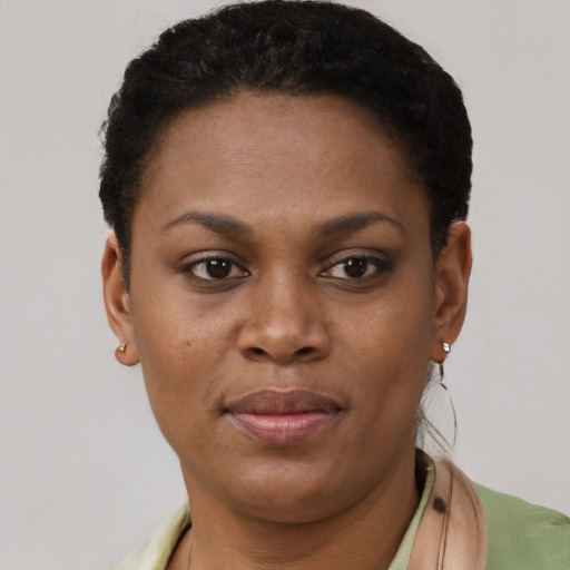 Joyful black young-adult female with short  brown hair and brown eyes