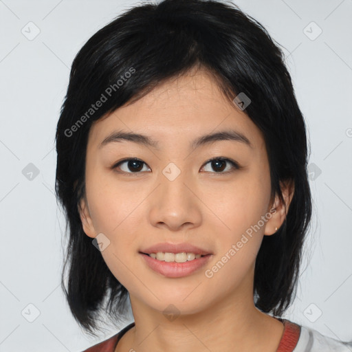 Joyful asian young-adult female with medium  black hair and brown eyes