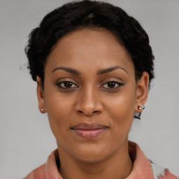 Joyful latino young-adult female with short  brown hair and brown eyes