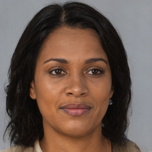 Joyful black young-adult female with medium  brown hair and brown eyes