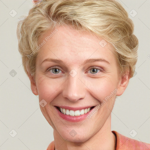 Joyful white young-adult female with short  brown hair and blue eyes