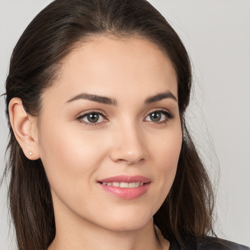 Joyful white young-adult female with long  brown hair and brown eyes