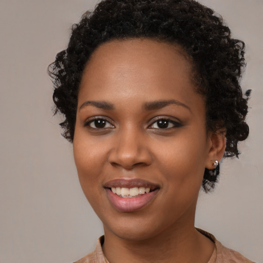 Joyful black young-adult female with medium  black hair and brown eyes