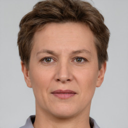 Joyful white adult female with short  brown hair and grey eyes