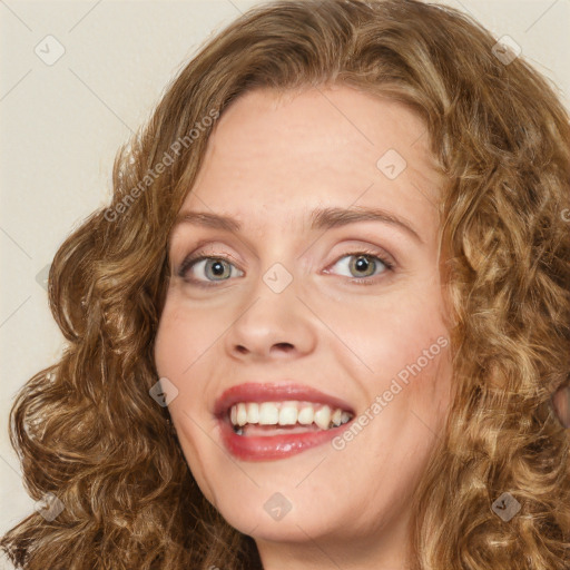 Joyful white young-adult female with long  brown hair and green eyes