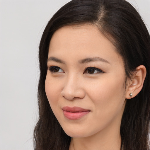 Joyful asian young-adult female with long  brown hair and brown eyes
