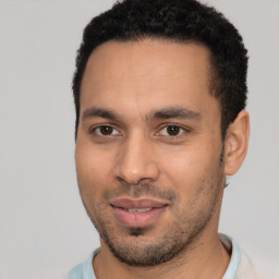 Joyful white young-adult male with short  black hair and brown eyes