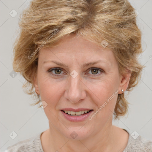 Joyful white adult female with medium  brown hair and blue eyes