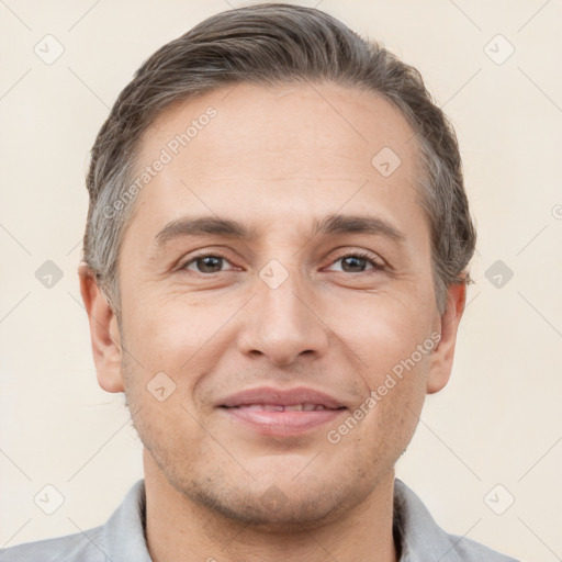 Joyful white adult male with short  brown hair and brown eyes