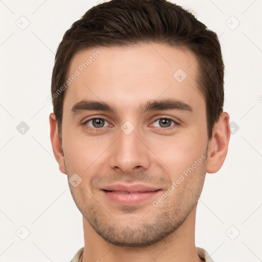 Joyful white young-adult male with short  brown hair and brown eyes