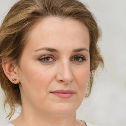 Joyful white adult female with medium  brown hair and green eyes