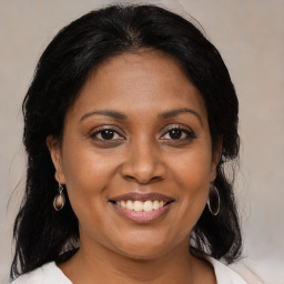 Joyful black adult female with medium  brown hair and brown eyes