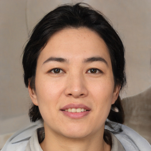 Joyful white young-adult female with medium  black hair and brown eyes