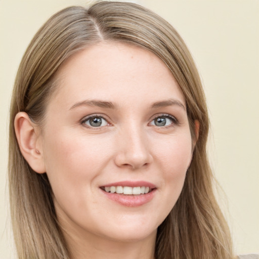 Joyful white young-adult female with long  brown hair and blue eyes