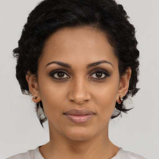 Joyful black young-adult female with short  brown hair and brown eyes