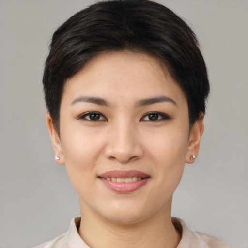 Joyful asian young-adult female with short  brown hair and brown eyes