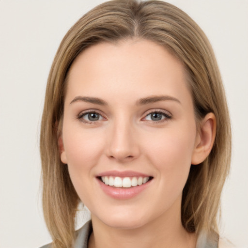 Joyful white young-adult female with medium  brown hair and green eyes