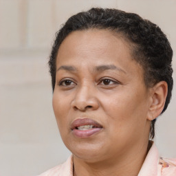 Joyful latino adult female with short  brown hair and brown eyes