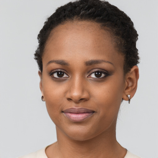Joyful black young-adult female with short  brown hair and brown eyes