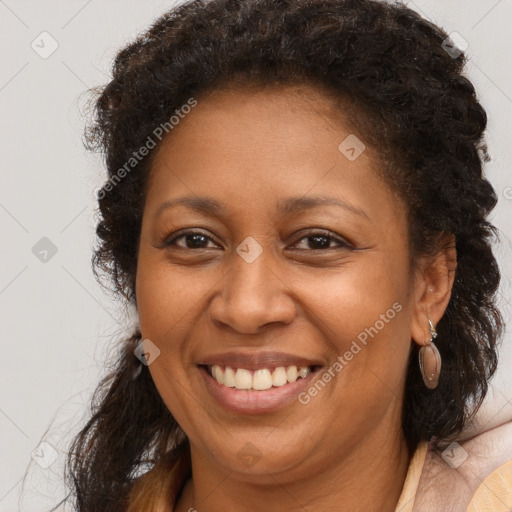 Joyful black adult female with long  brown hair and brown eyes