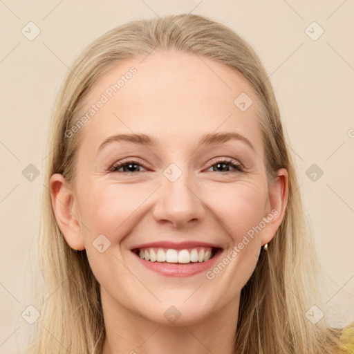 Joyful white young-adult female with long  brown hair and brown eyes